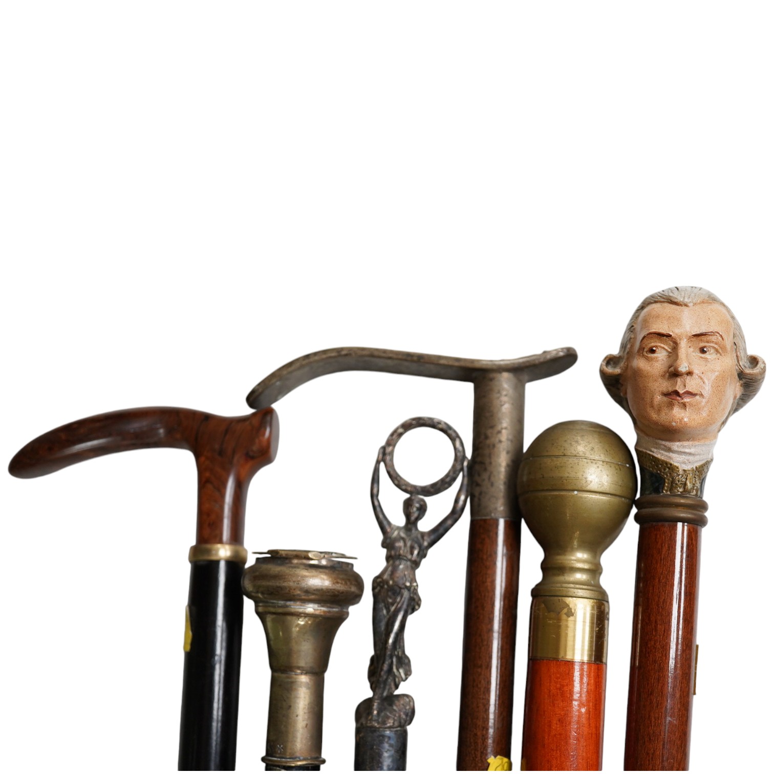 Six walking sticks, one with a plated snuff box handle, a stick with hidden glass flask, a stick with a handle in the form of a Georgian gentleman, etc. longest 95cm. Condition - fair to good